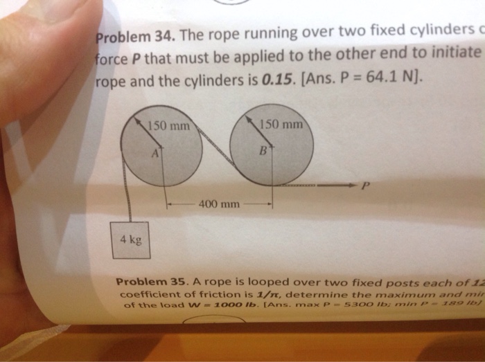 Solved the rope running over two fixed cylinders carries the
